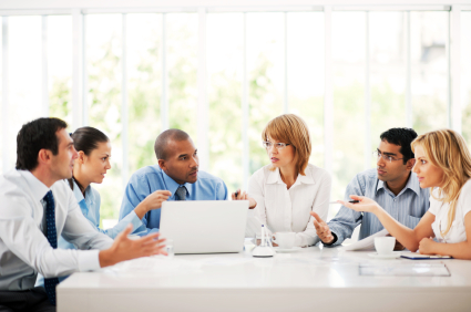 Businesspeople working on laptop in an office.